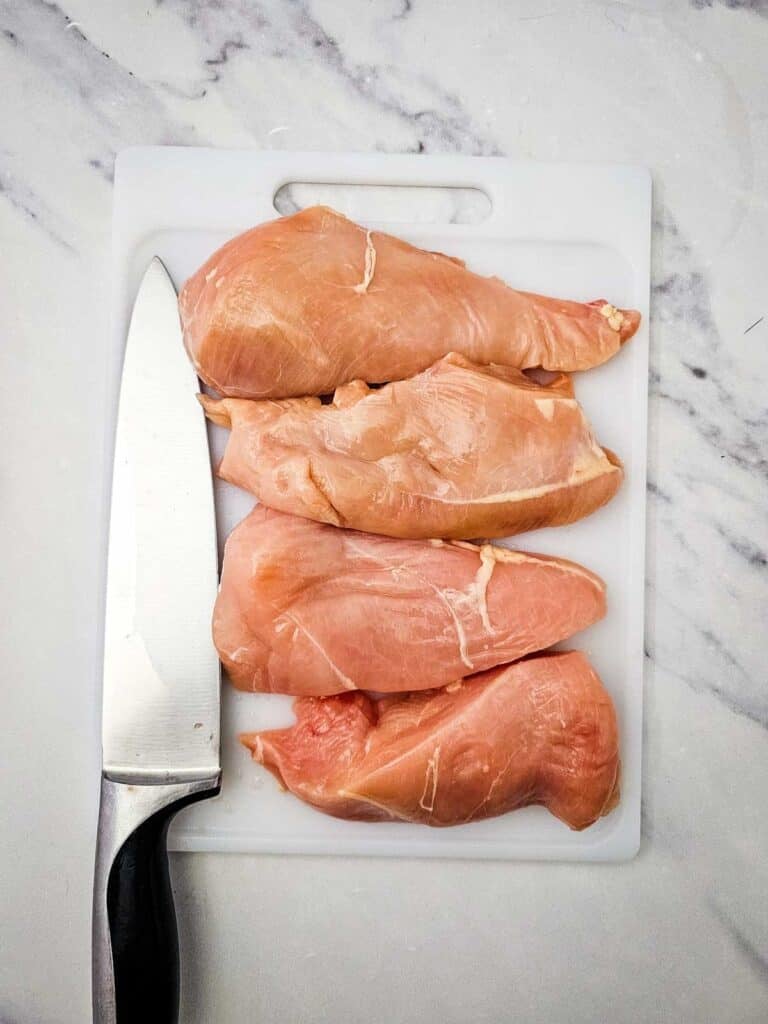 chicken breasts on a cutting board