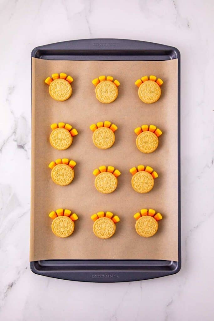 candy corn attached to golden oreos to form turkey tails