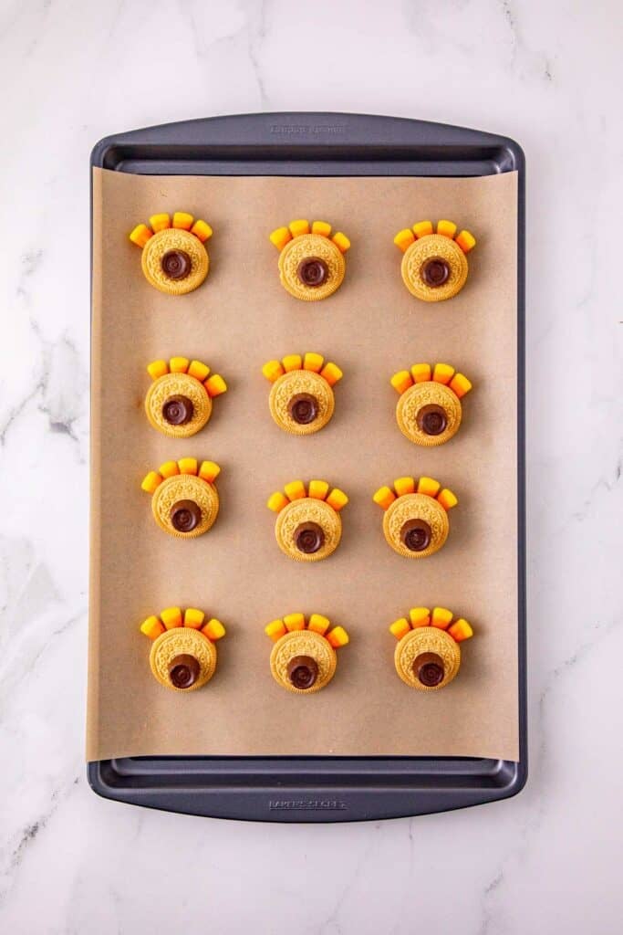 rolo candies on top of golden oreos with candy corn