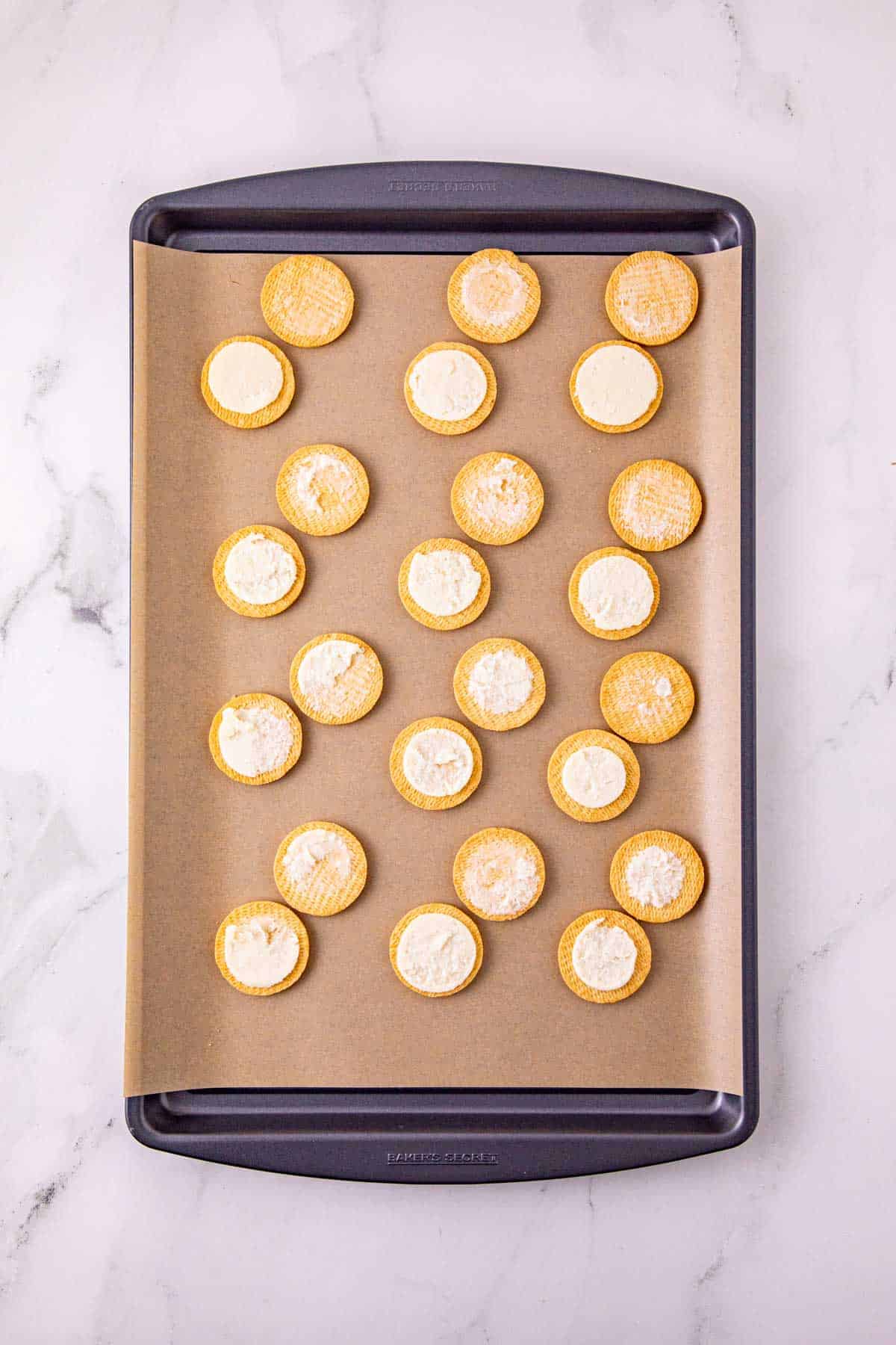 golden oreos split in half on a baking sheet