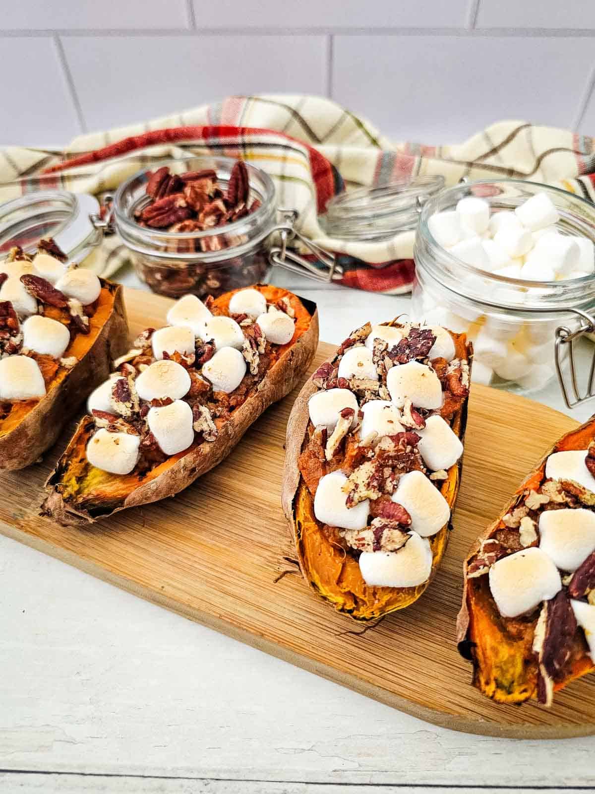 marshmallows and pecans on top of twice baked sweet potatoes