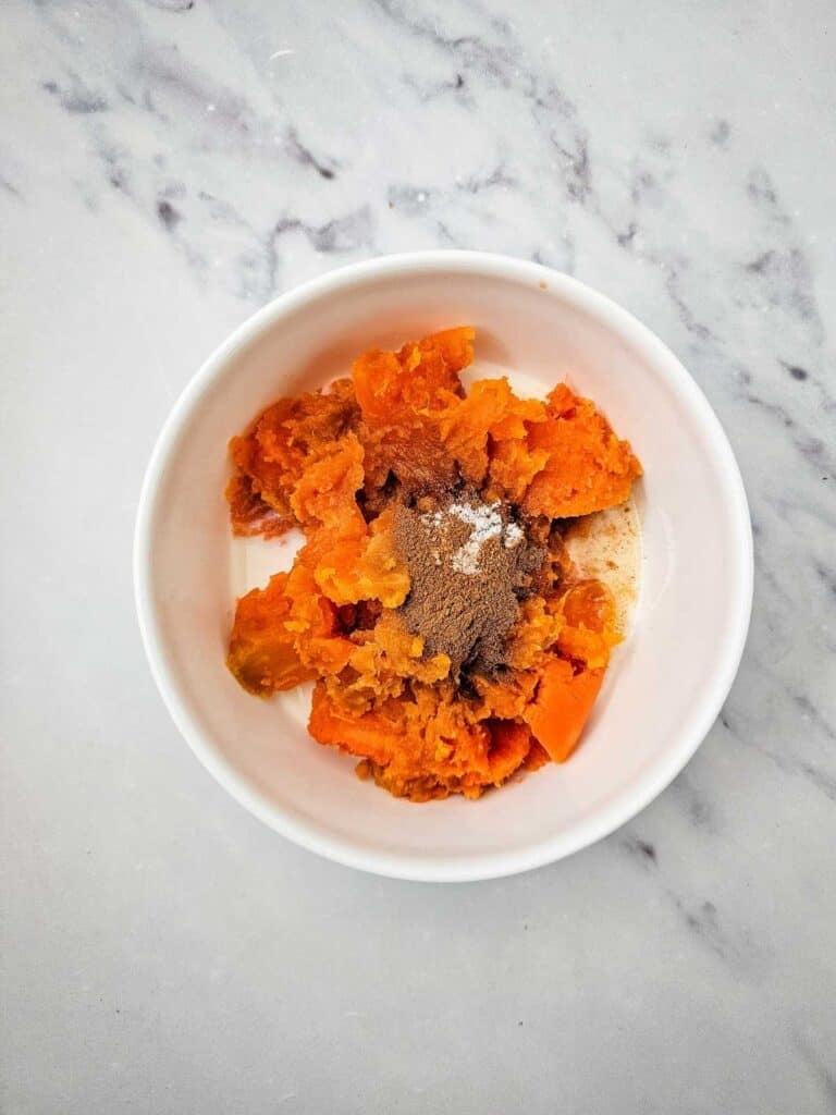 cinnamon, salt, vanilla and milk added to bowl with cooked sweet potato