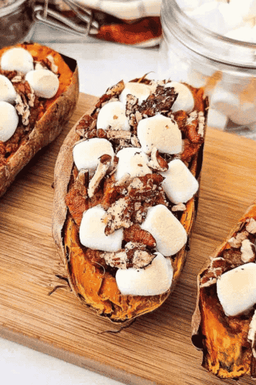 These Twice Baked Sweet Potatoes are an easy holiday side dish made with tender baked sweet potatoes, creamy cinnamon vanilla filling, mini marshmallows, and crunchy pecans. This simple sweet potato recipe is perfect for Thanksgiving dinner, Christmas dinner, fall meals, Easter sides, or cozy family dinners when you want something sweet, warm, and comforting. If you love sweet potato casserole, candied sweet potatoes, marshmallow sweet potatoes, or classic holiday side dishes, this individual twice baked version is a fun and delicious option. Serve these baked sweet potatoes with turkey, ham, chicken, pork chops, or your favorite comfort food dinner for a crowd pleasing side dish everyone will want again.