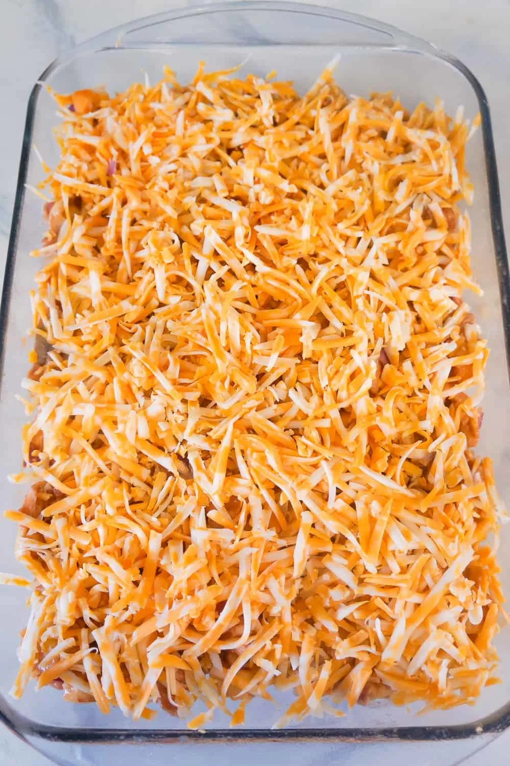 shredded cheddar cheese on top of chicken tortellini