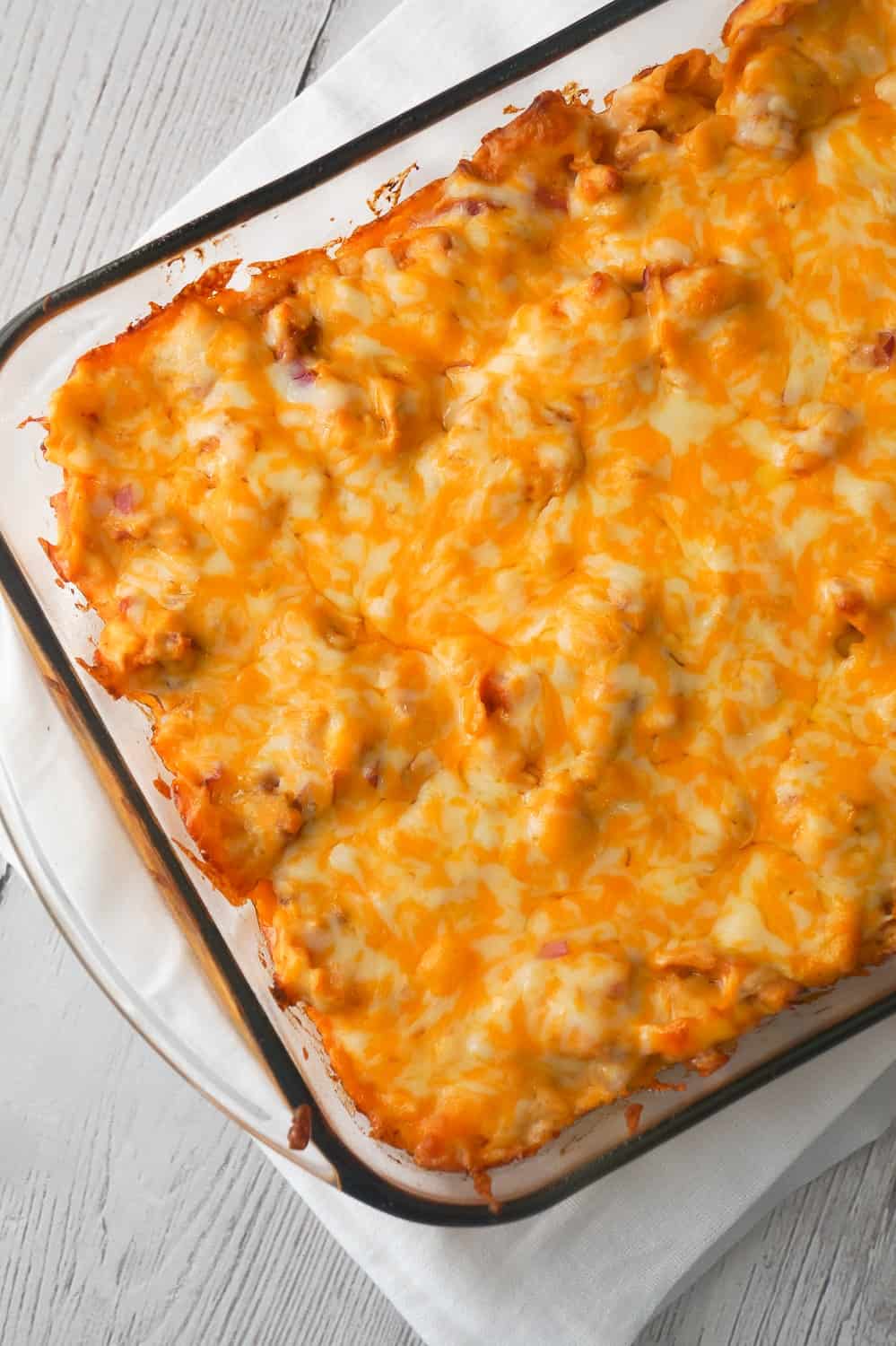 BBQ Chicken Tortellini Casserole is an easy dinner recipe using rotisserie chicken. This baked tortellini is loaded with bacon, chicken, red onions, BBQ sauce and cheddar cheese.