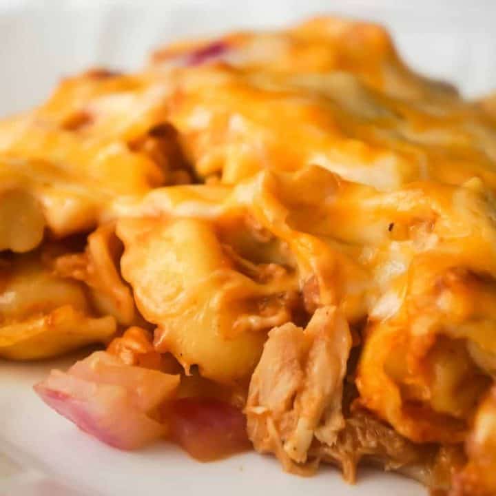 BBQ Chicken Tortellini Casserole is an easy dinner recipe using rotisserie chicken. This baked tortellini is loaded with bacon, chicken, red onions, BBQ sauce and cheddar cheese.