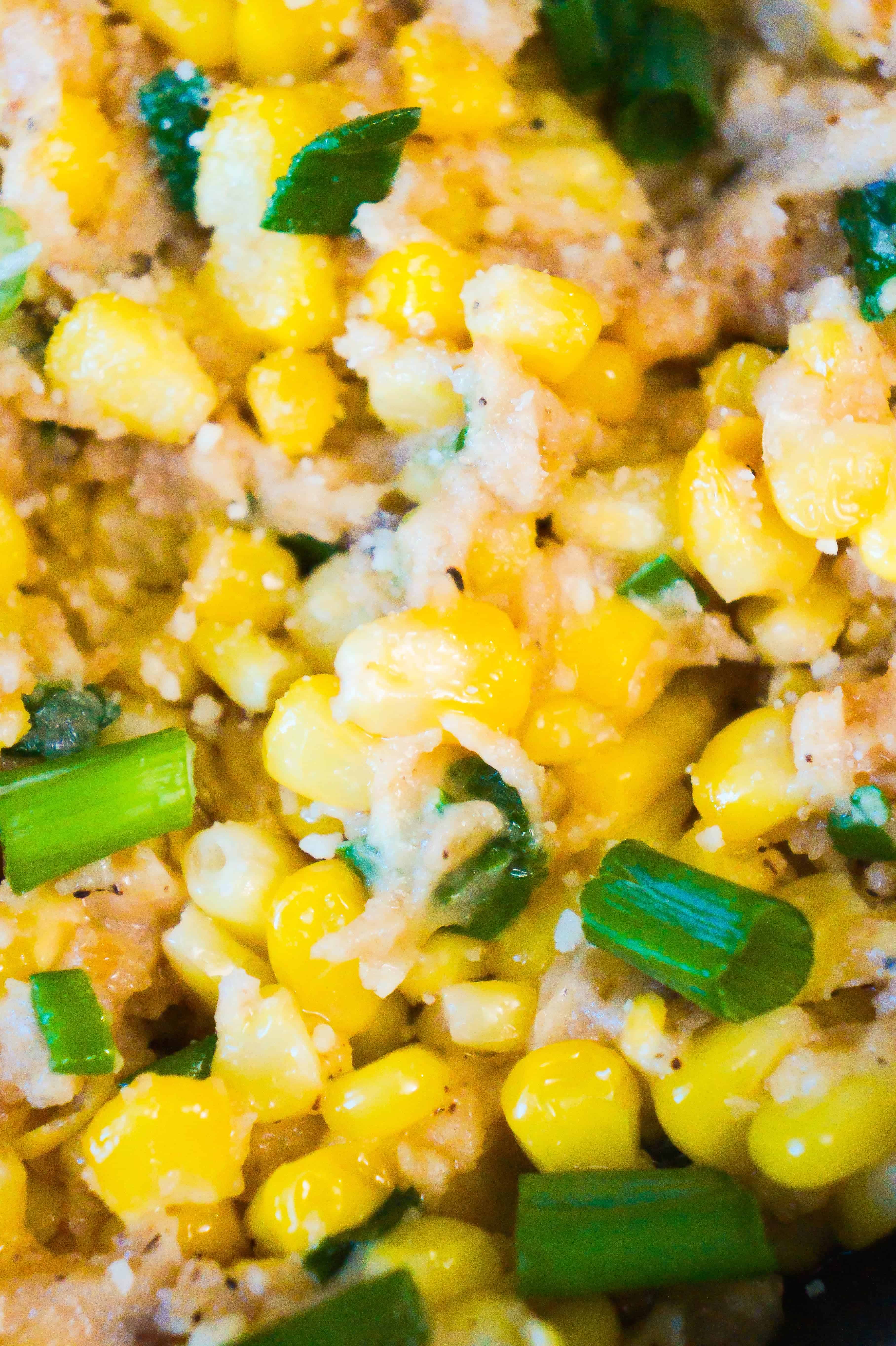 Corn side dish with green onions and Swiss cheese.
