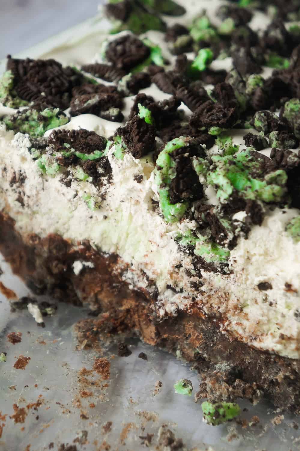 Mint Oreo Ice Cream Cake is an easy no bake dessert recipe perfect for summer. This mint chocolate chip ice cream cake is loaded with mint Oreo cookies, brownies, chocolate fudge sauce and Cool Whip.