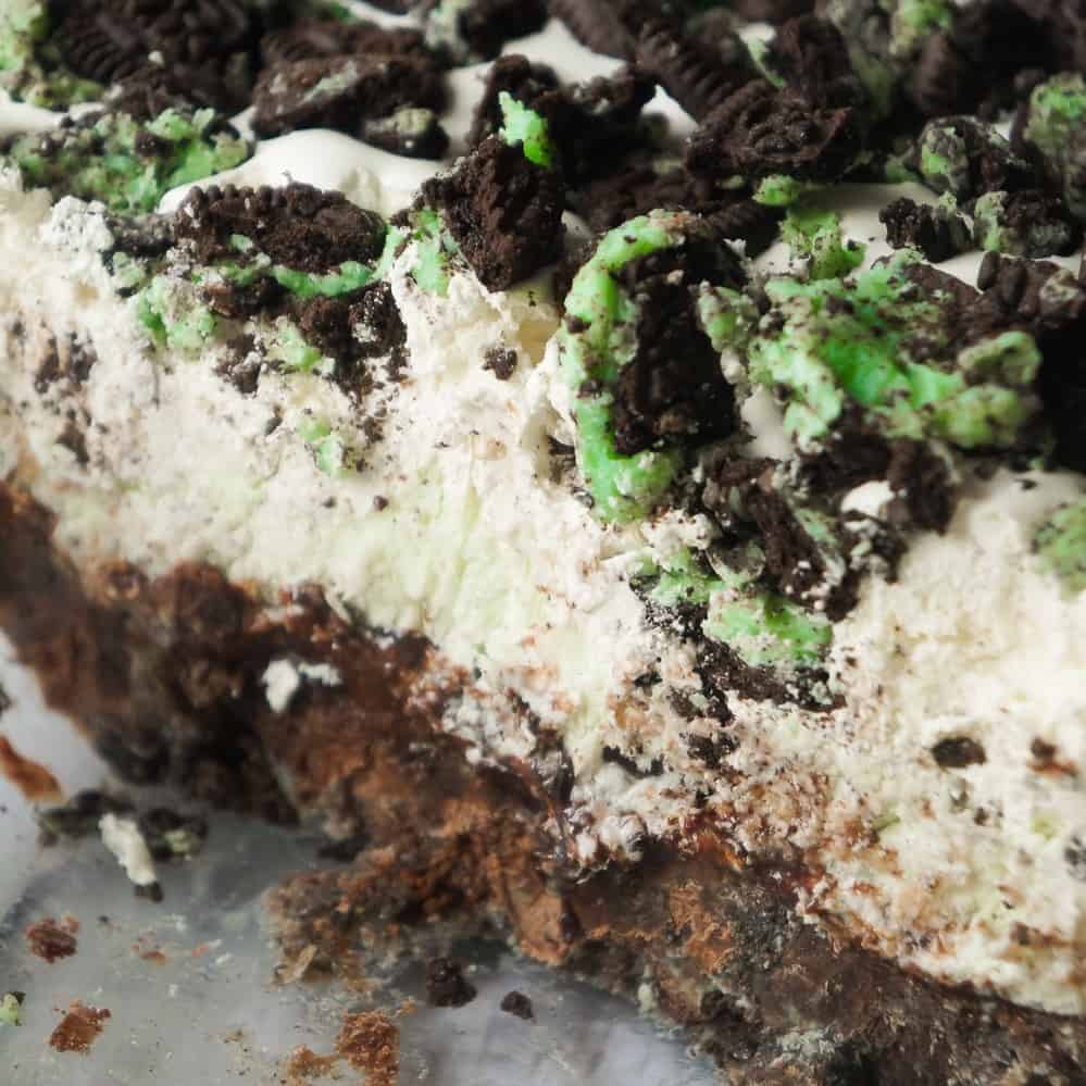 Mint Oreo Ice Cream Cake is an easy no bake dessert recipe perfect for summer. This mint chocolate chip ice cream cake is loaded with mint Oreo cookies, brownies, chocolate fudge sauce and Cool Whip.