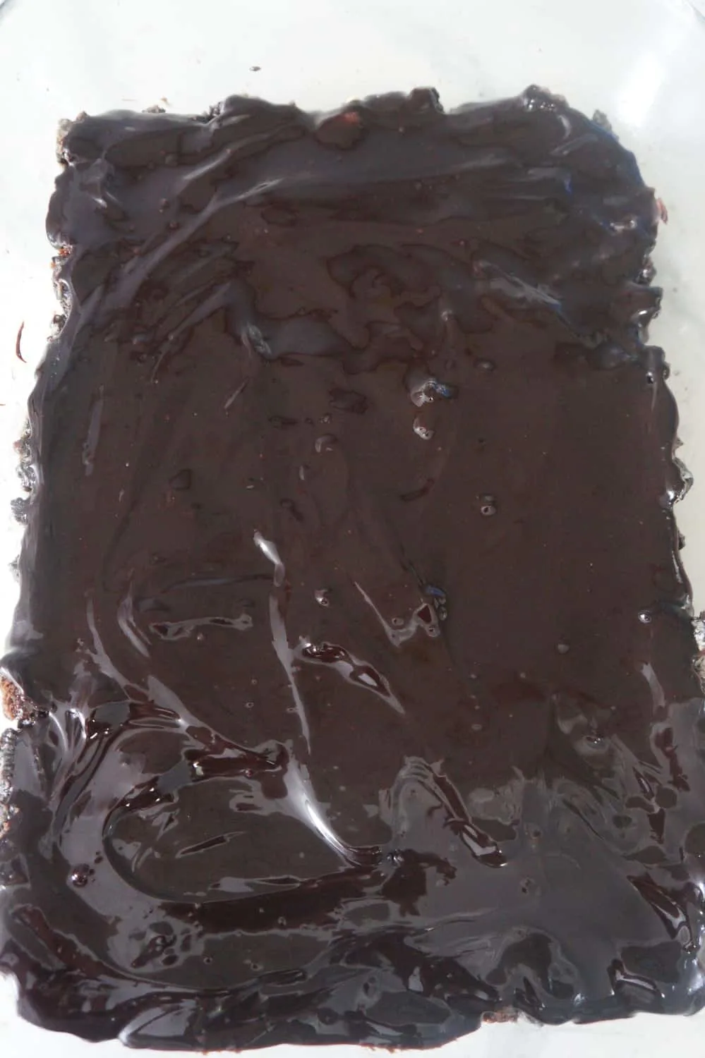 chocolate fudge topping spread over Oreo base
