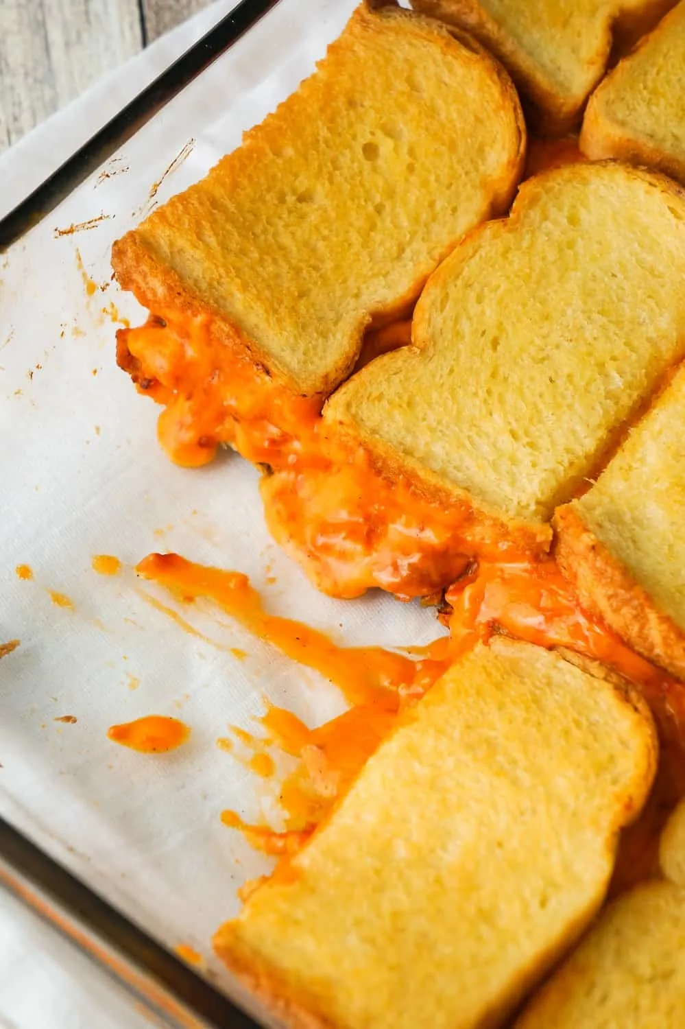 Tomato Soup & Bacon Grilled Cheese Casserole is an easy lunch or dinner recipe the whole family will love. This easy casserole is loaded with shredded cheddar cheese, real bacon bits and condensed tomato soup, all sandwiched between two layers of bread.