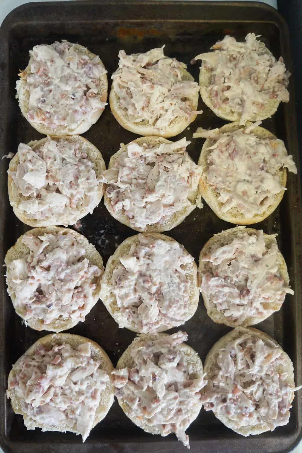 English muffins topped with chicken Alfredo mixture