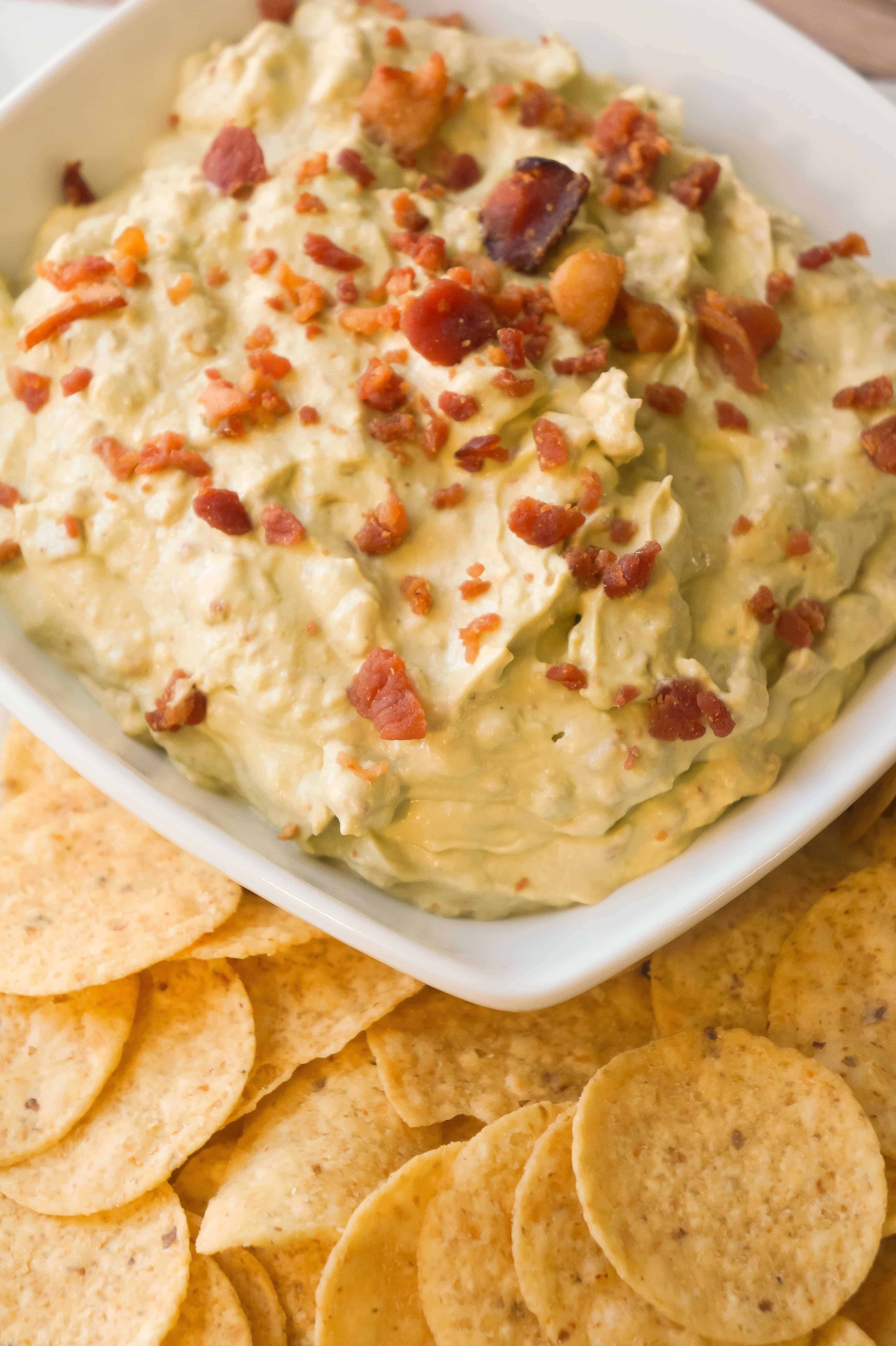 Bacon Cream Cheese Avocado Dip is the perfect party chip dip recipe. If you like guacamole but are looking for something a little richer you will love this avocado dip loaded with cream cheese and real bacon bits.