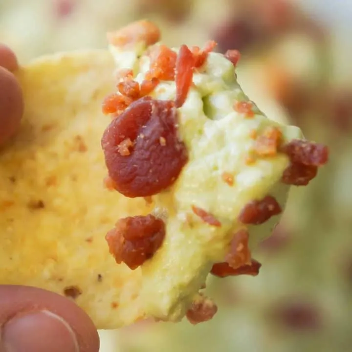 Bacon Cream Cheese Avocado Dip is the perfect party chip dip recipe. If you like guacamole but are looking for something a little richer you will love this avocado dip loaded with cream cheese and real bacon bits.