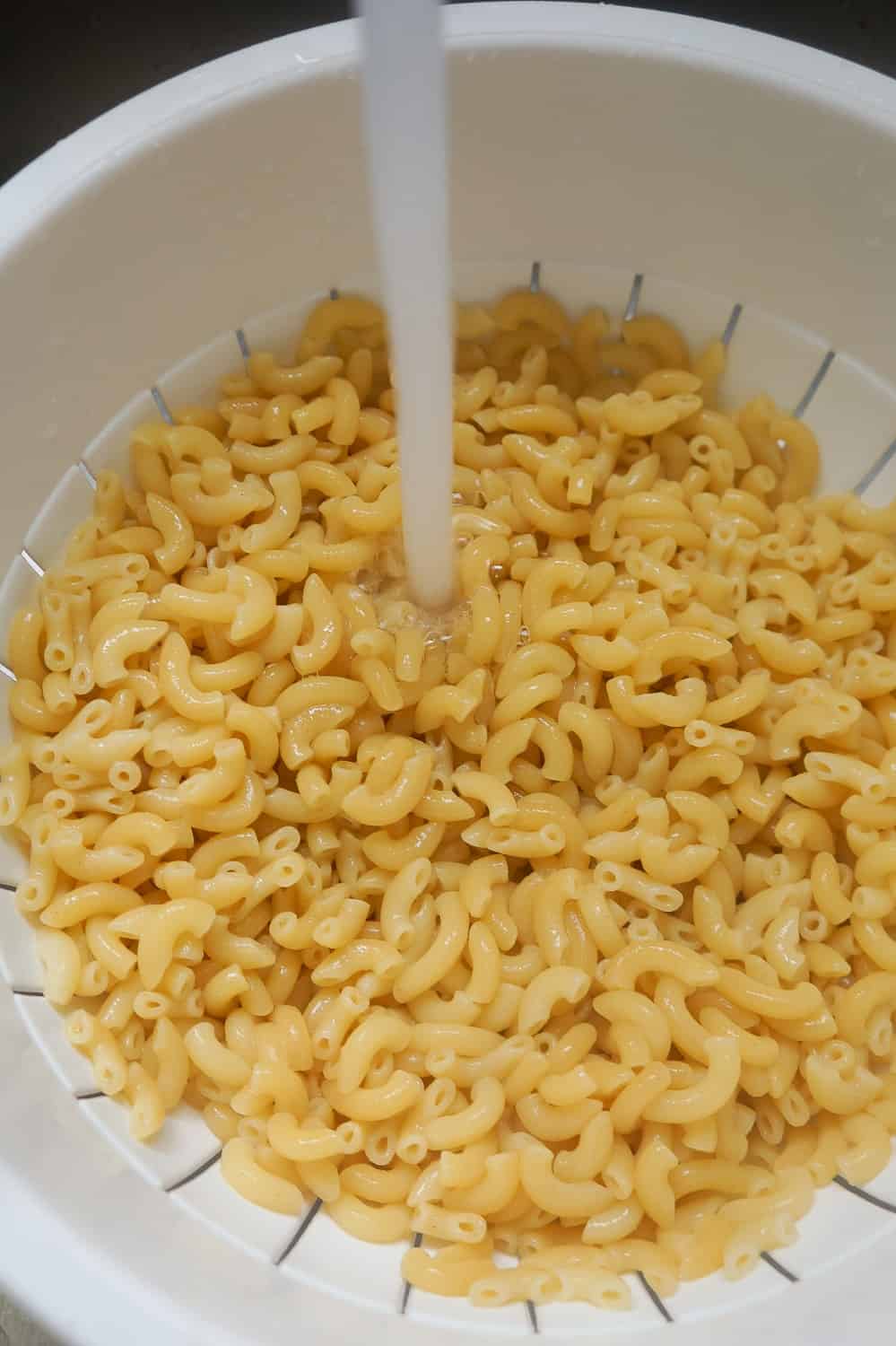 cooked macaroni cooling down in the sink