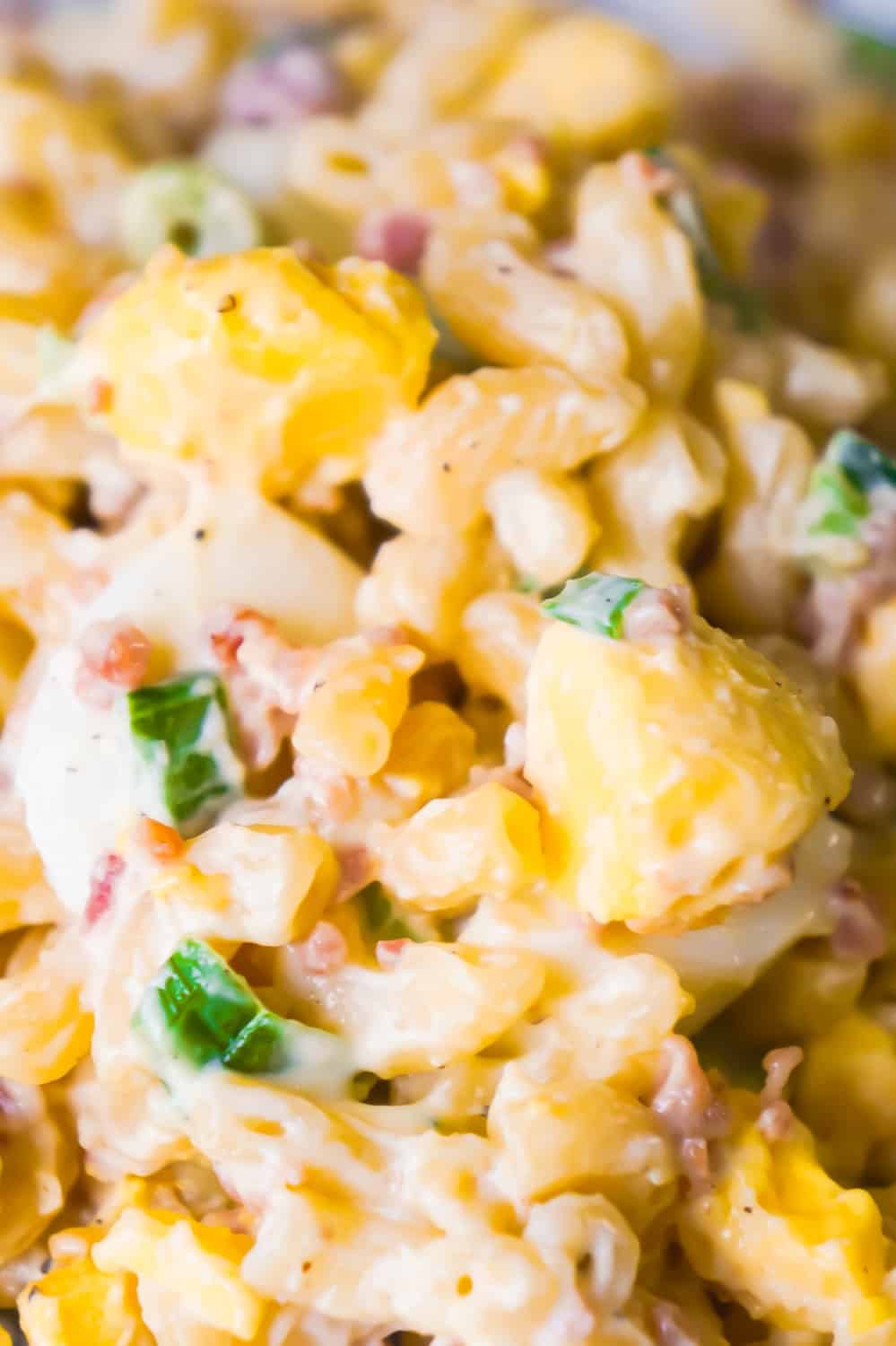 Bacon Egg Pasta Salad is a delicious cold side dish recipe. This pasta salad loaded with real bacon bits and hard boiled eggs is perfect for potlucks and BBQs.