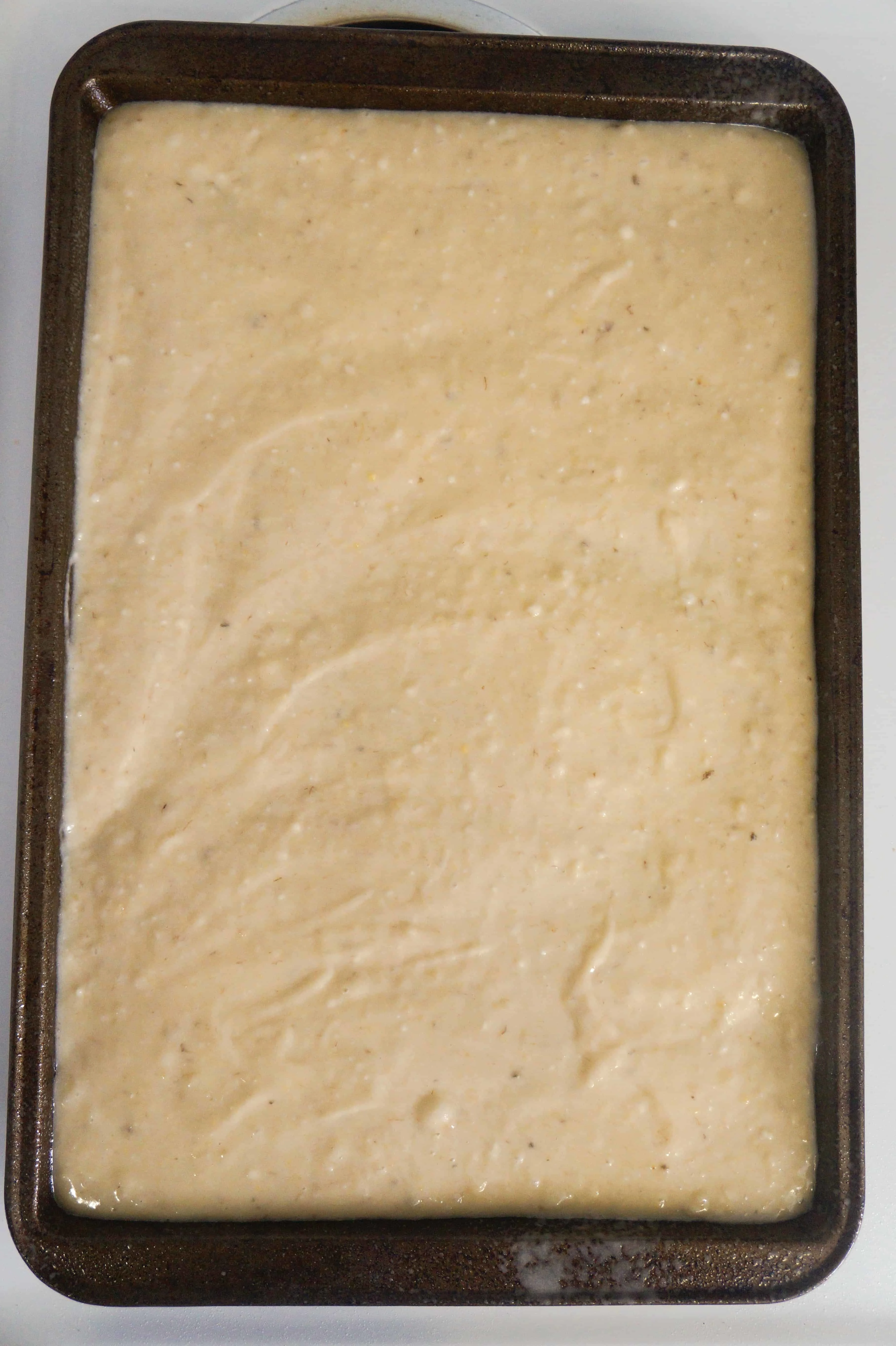 banana sugar cookie mix spread on a cookie sheet
