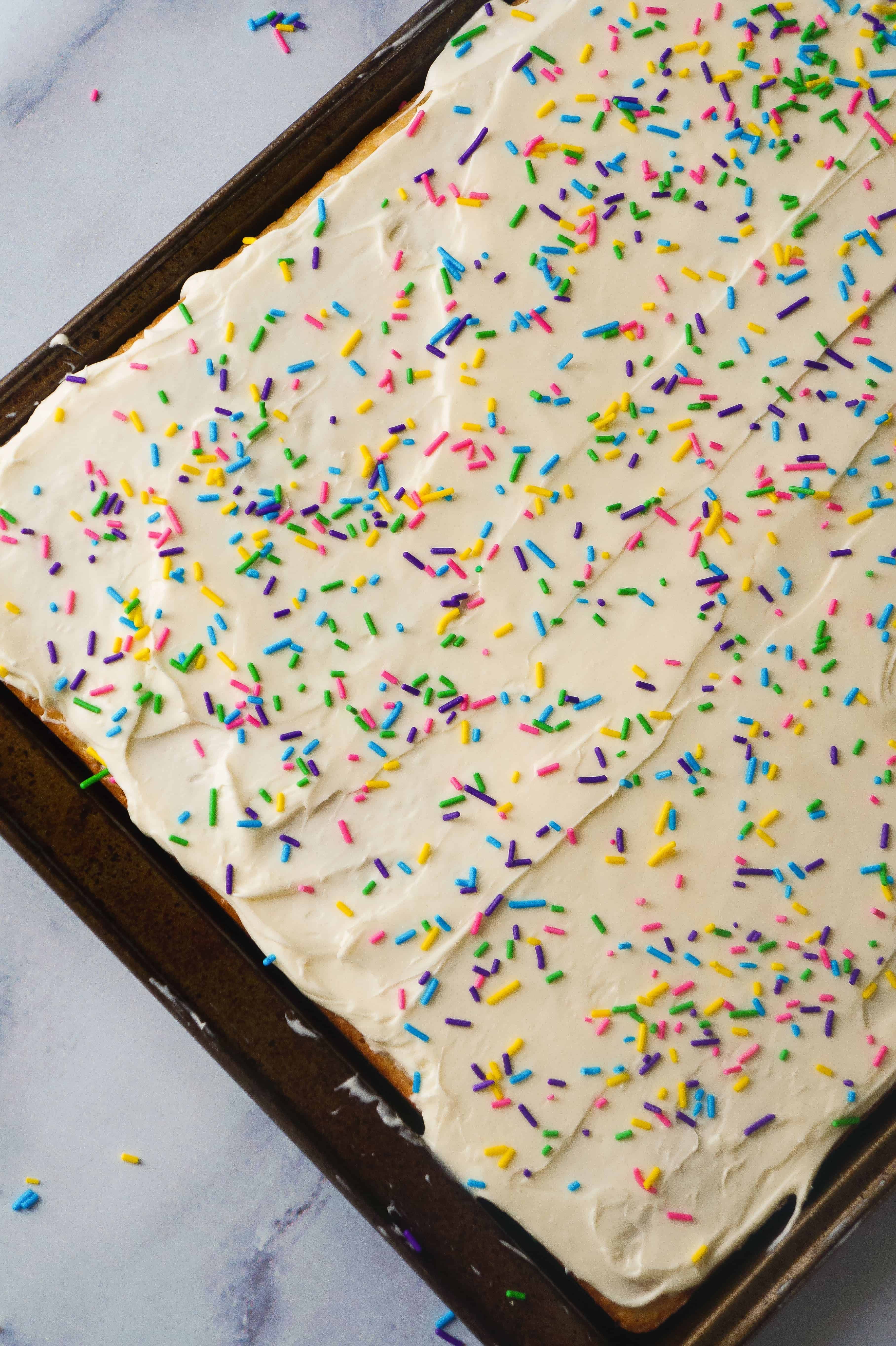 Banana Sugar Cookie Bars are an easy dessert recipe using only five ingredients. Sugar Cookie mix and ripe bananas form the base of these cookie bars which are topped with vanilla icing and colourful sprinkles.