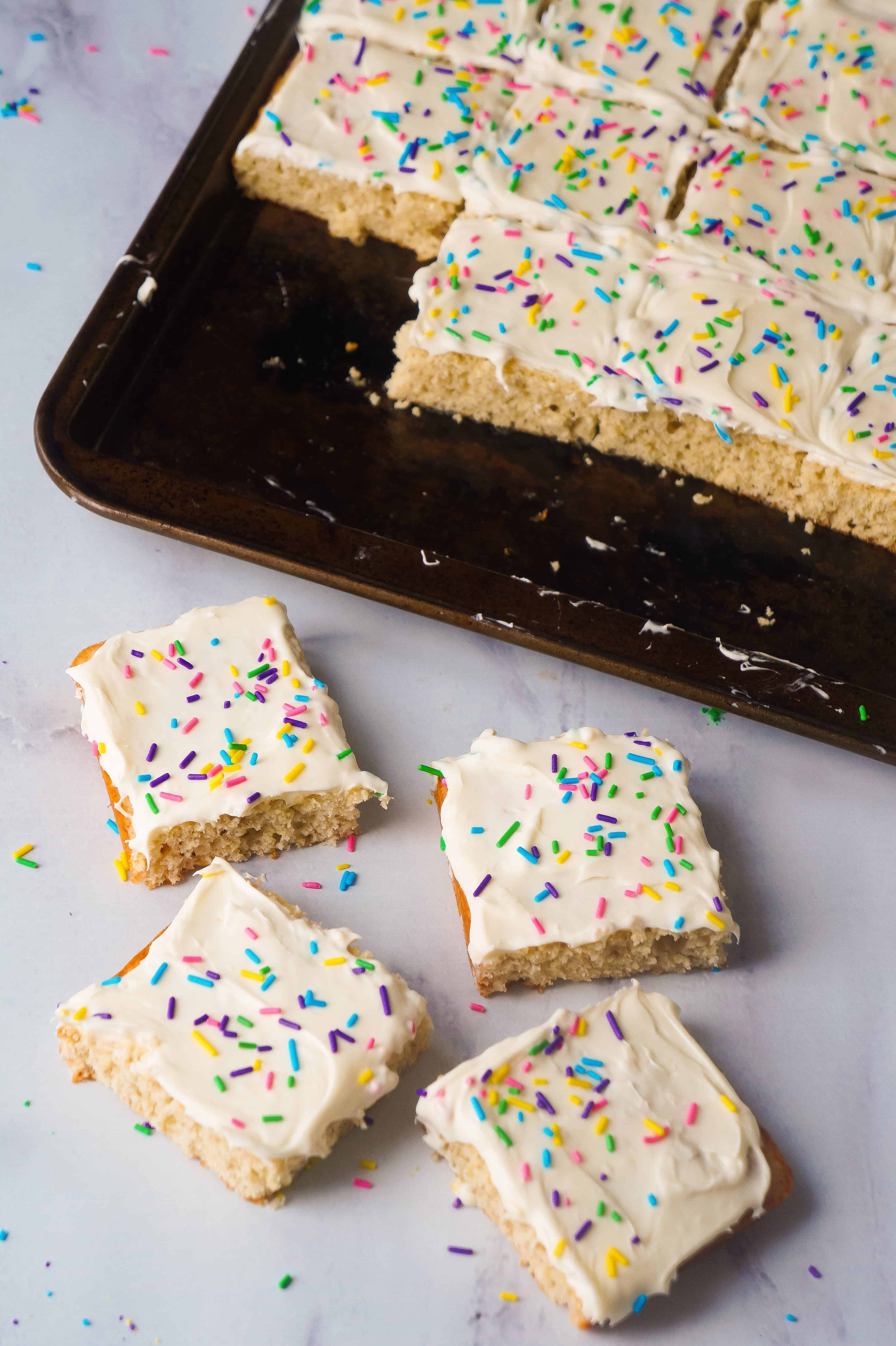 Banana Sugar Cookie Bars are an easy dessert recipe using only five ingredients. Sugar Cookie mix and ripe bananas form the base of these cookie bars which are topped with vanilla icing and colourful sprinkles.