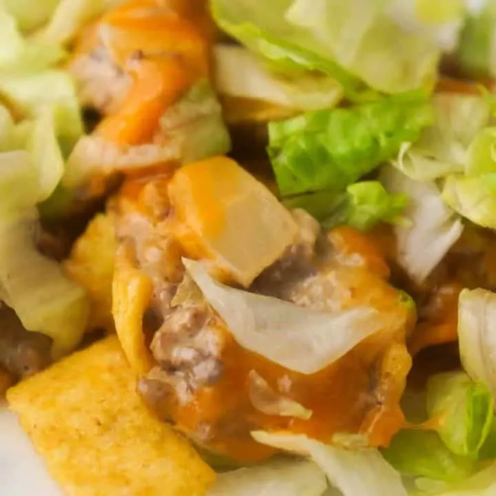 Big Mac Frito Pie is an easy ground beef dinner recipe that can be on the table in under 30 minutes. Frito's corn chips are topped with ground beef mixed with Big Mac sauce, diced pickles and cheddar cheese.