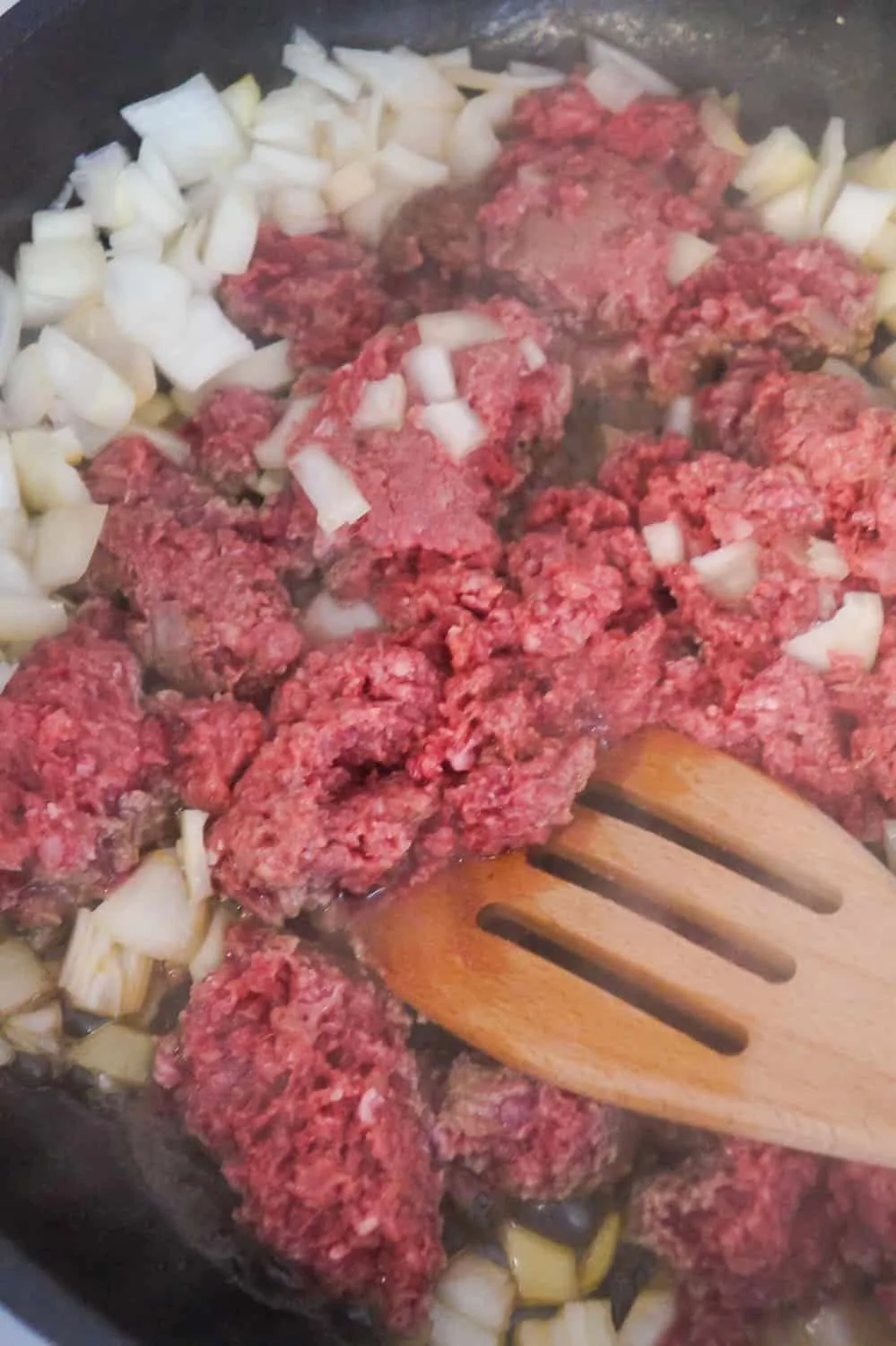 frying ground beef and onions in a pan