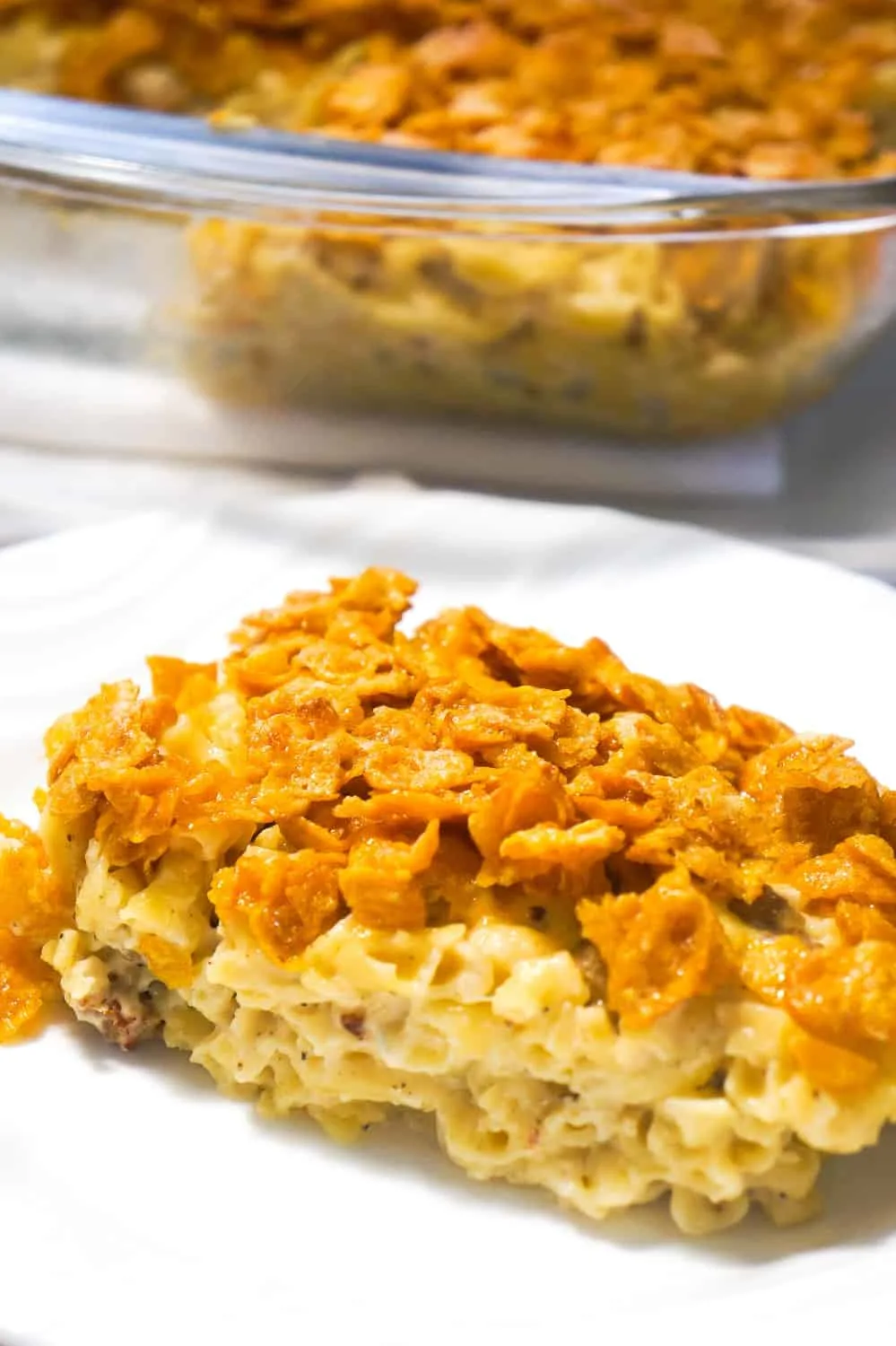 Breakfast Sausage Mac and Cheese topped with Frosted Flakes is a delicious brunch recipe with the perfect balance of savoury and sweet. This homemade macaroni and cheese is loaded with Havarti cheese and chunks of maple breakfast sausages with a crispy coating of frosted flakes.