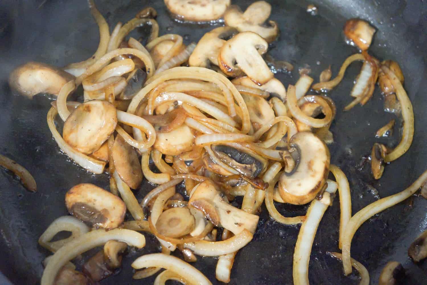 fried mushrooms and onions in pan