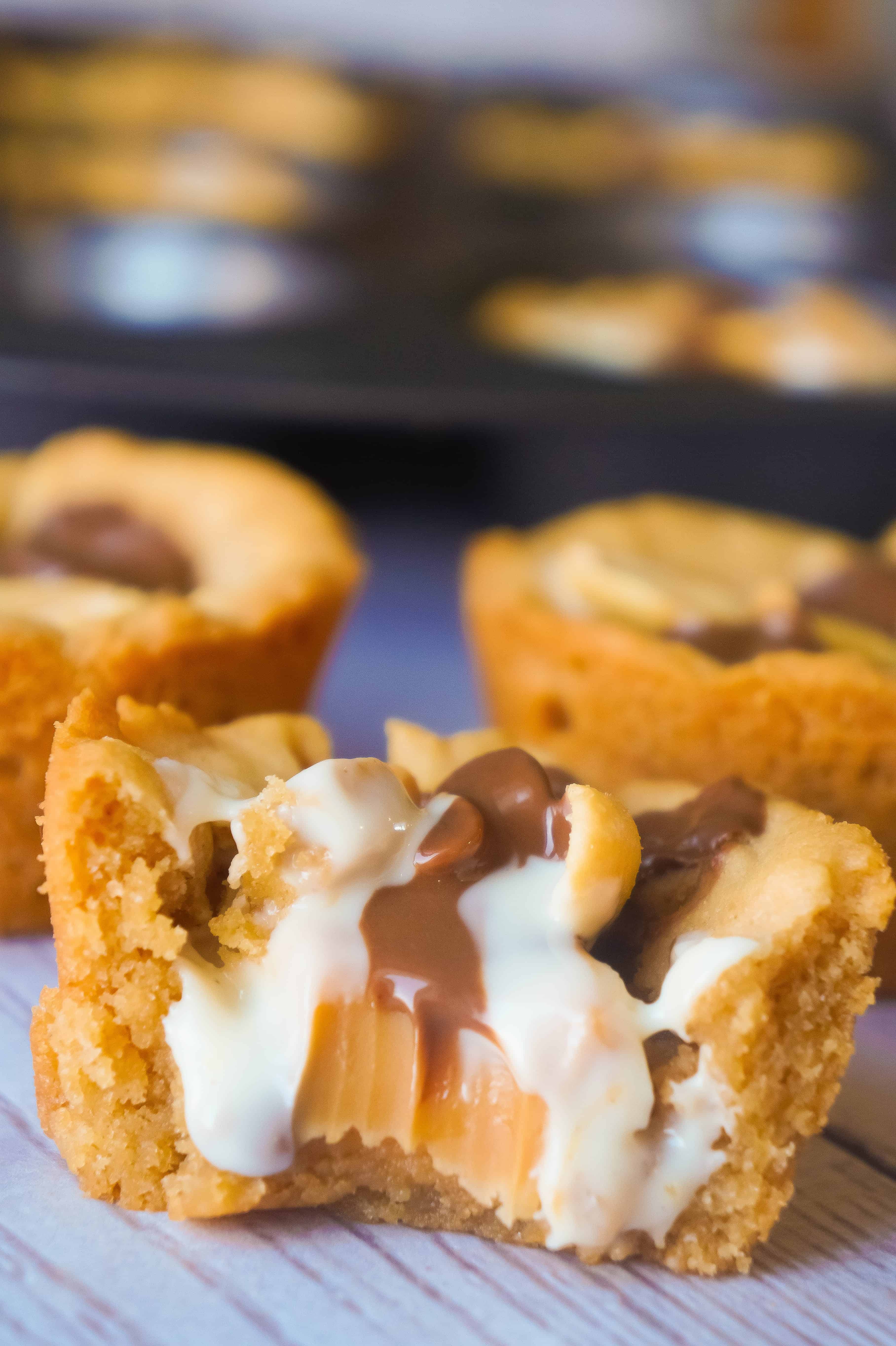 Caramel Peanut Butter Cookie Cups are an easy peanut butter dessert recipe. These cookie cups are filled with caramels, mini peanut butter cups, white chocolate peanut butter cups and roasted peanuts.