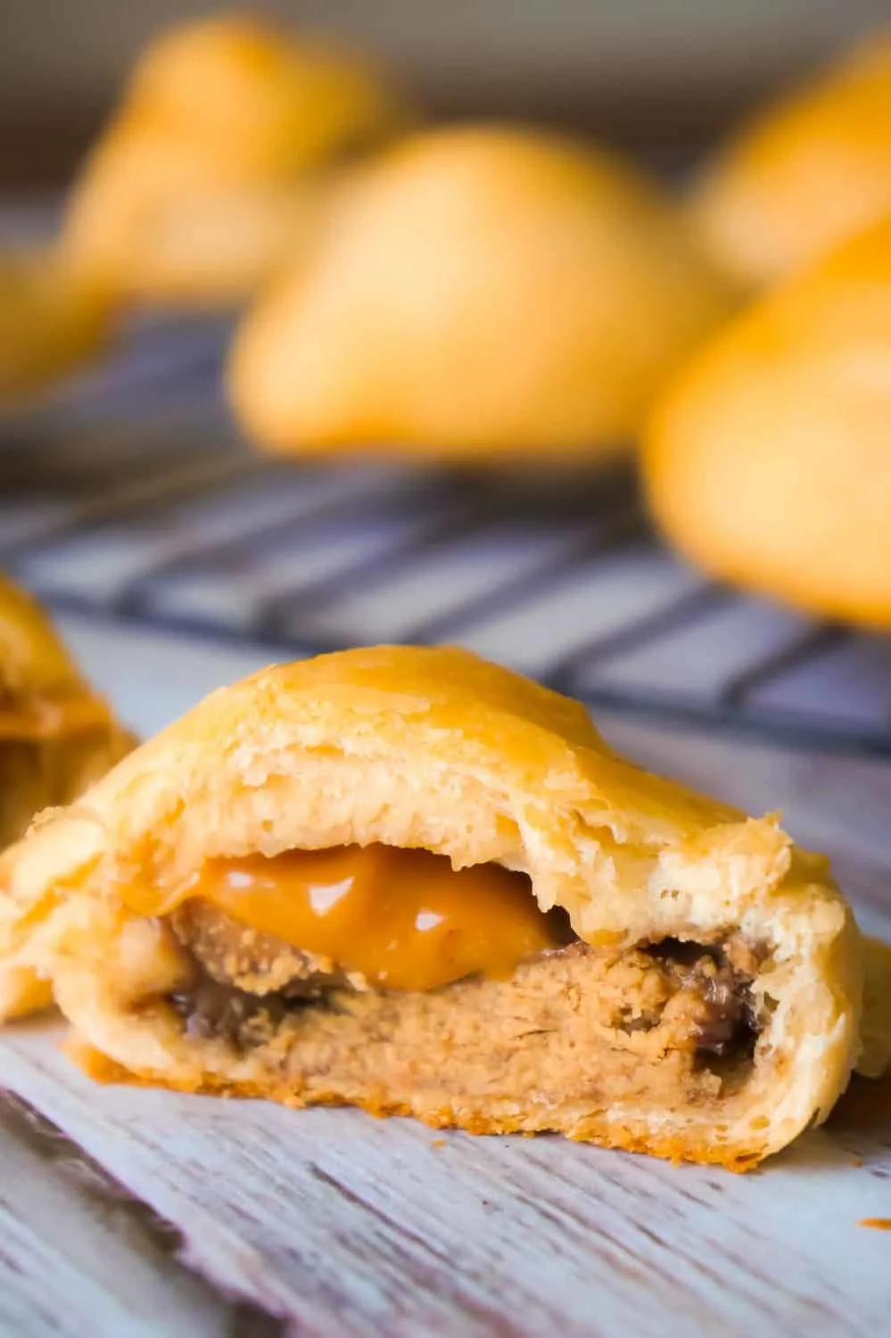 Caramel Peanut Butter Cup Stuffed Crescent Rolls are an easy three ingredient dessert recipe. These Pillsbury crescent rolls are filled with Reese's Peanut Butter Cups and Kraft Caramels.