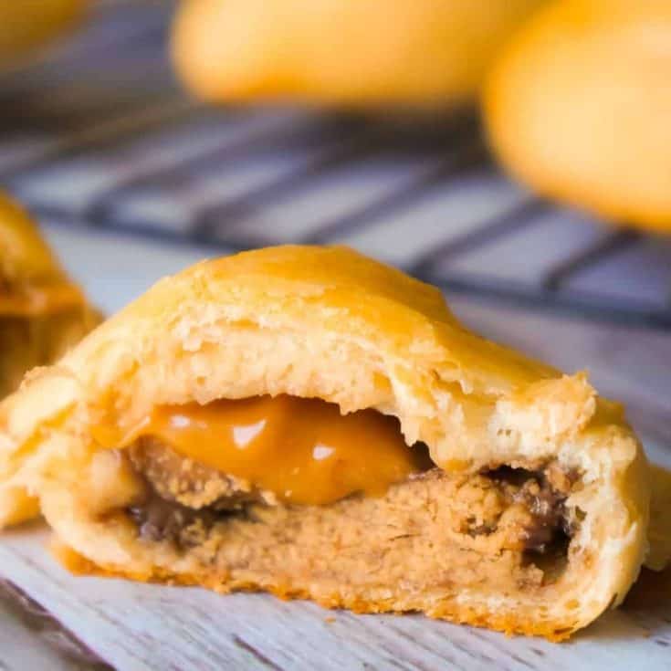 Caramel Peanut Butter Cup Stuffed Crescent Rolls are an easy three ingredient dessert recipe. These Pillsbury crescent rolls are filled with Reese's Peanut Butter Cups and Kraft Caramels.