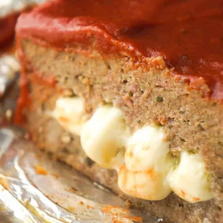 Cheese Stuffed Ground Chicken Meatloaf is an easy dinner recipe loaded with Italian flavours. This chicken meatloaf is made with Italian seasoned bread crumbs, basil pesto, mozzarella cheese and topped with pizza sauce.