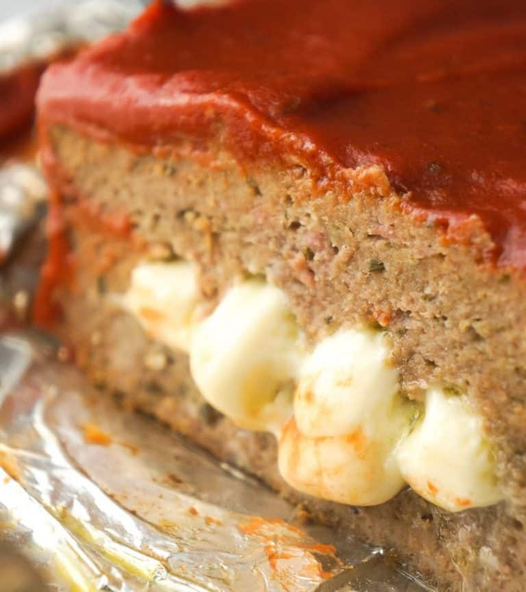 Cheese Stuffed Ground Chicken Meatloaf is an easy dinner recipe loaded with Italian flavours. This chicken meatloaf is made with Italian seasoned bread crumbs, basil pesto, mozzarella cheese and topped with pizza sauce.