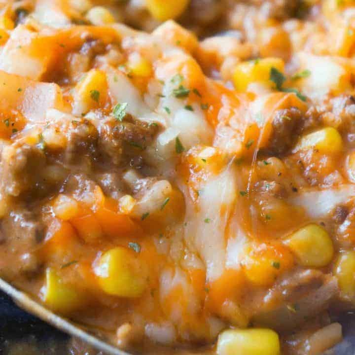 Cheesy Tomato Ground Beef and Rice is an easy stove top dinner recipe packed with flavour. This ground beef dish is made with cream of tomato soup, canned corn, instant rice and loaded with cheddar cheese.