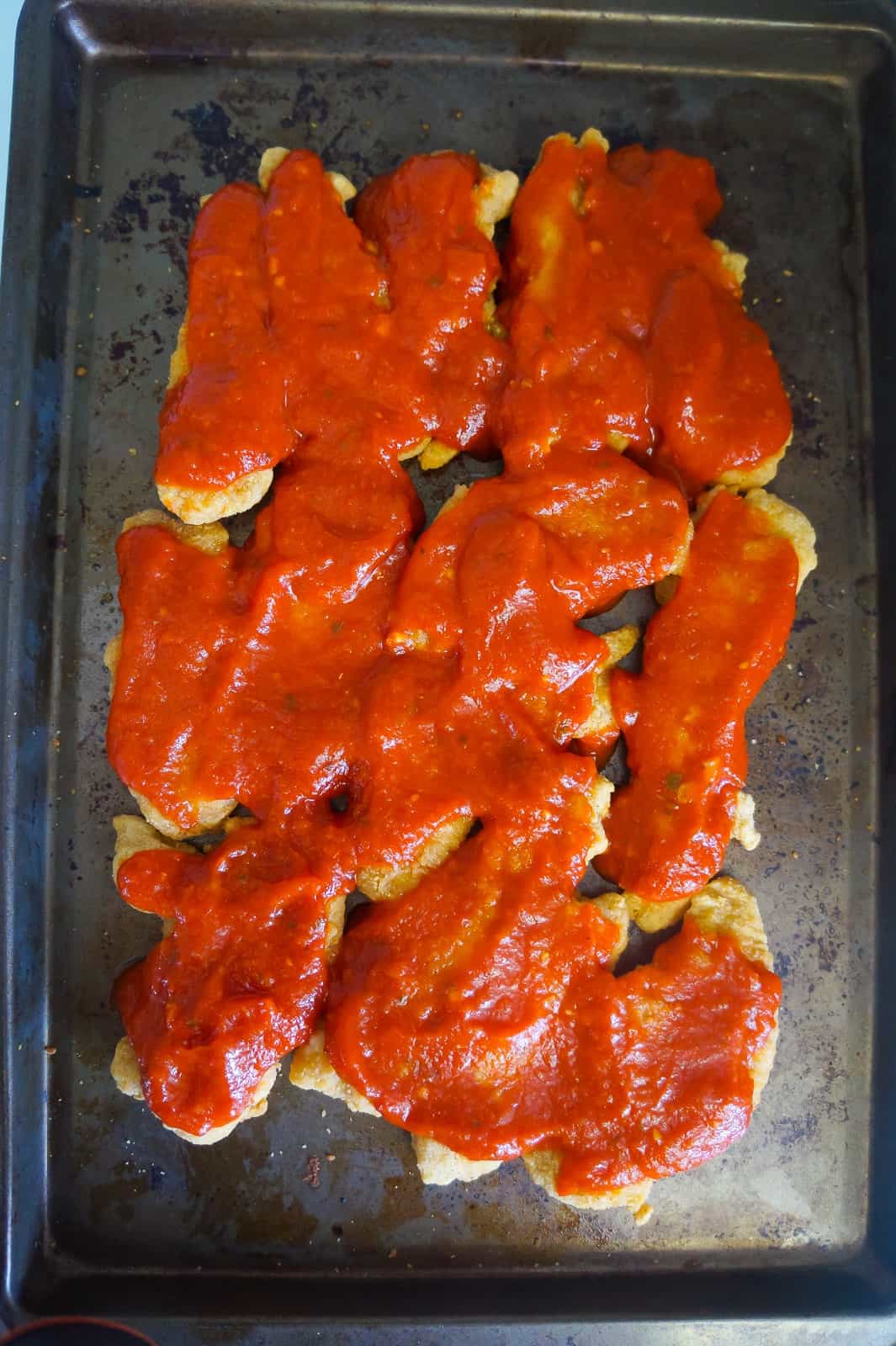 chicken fingers covered with marinara sauce