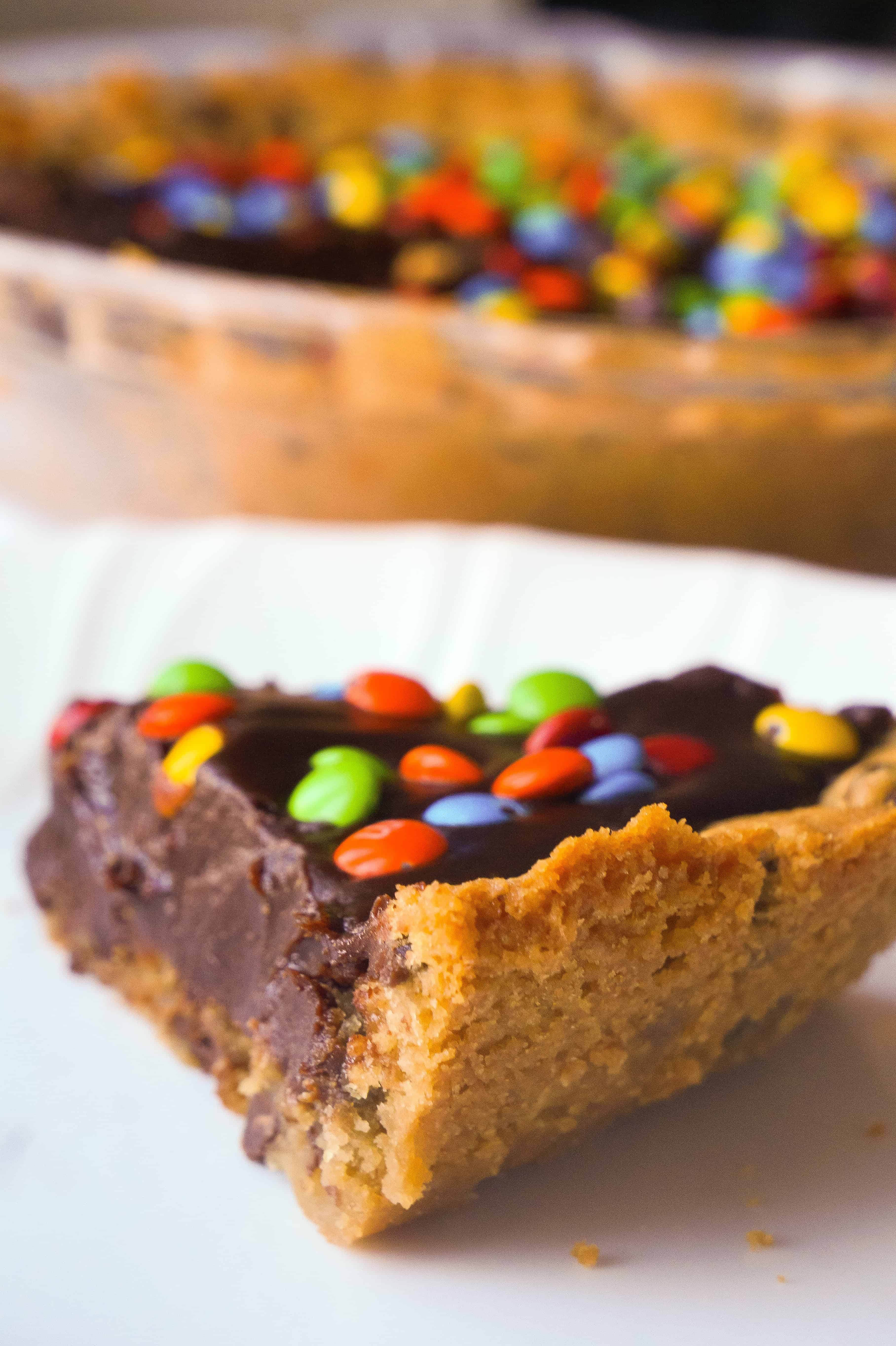 Chocolate Fudge Cookie Pie is a decadent dessert for chocolate lovers. This easy pie recipe starts with a chocolate chip cookie crust with a creamy chocolate filling and is topped with mini M&Ms.