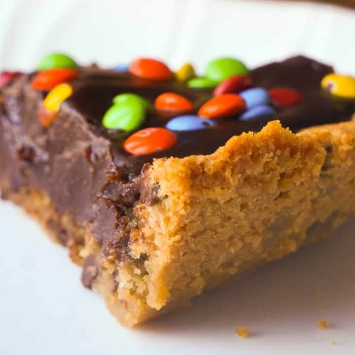 Chocolate Fudge Cookie Pie is a decadent dessert for chocolate lovers. This easy pie recipe starts with a chocolate chip cookie crust with a creamy chocolate filling and is topped with mini M&Ms.