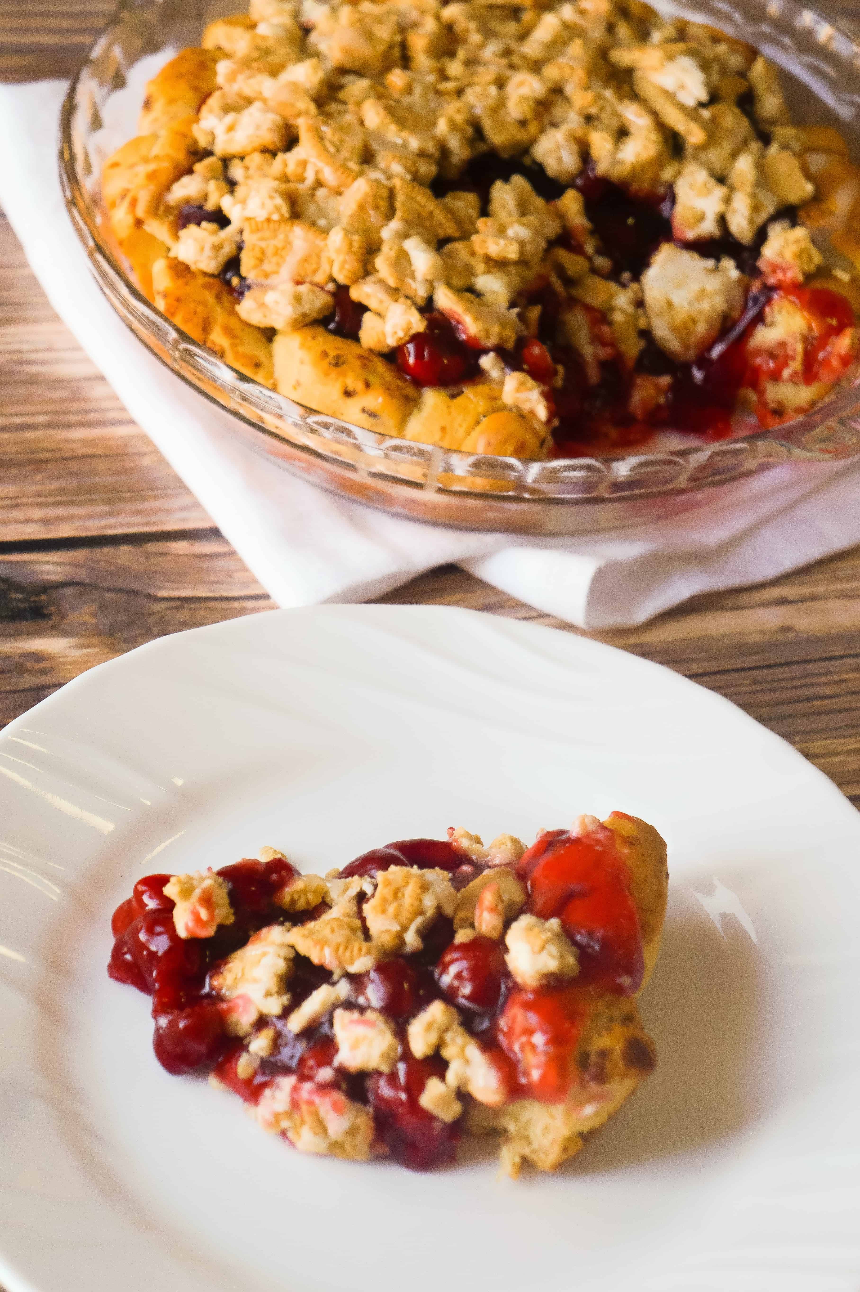 Cinnamon Bun Cherry Pie is an easy pie recipe using Pillsbury Cinnamon Rolls and canned cherry pie filling. This cherry pie is topped with crumbled Cinnamon Bun Oreos.