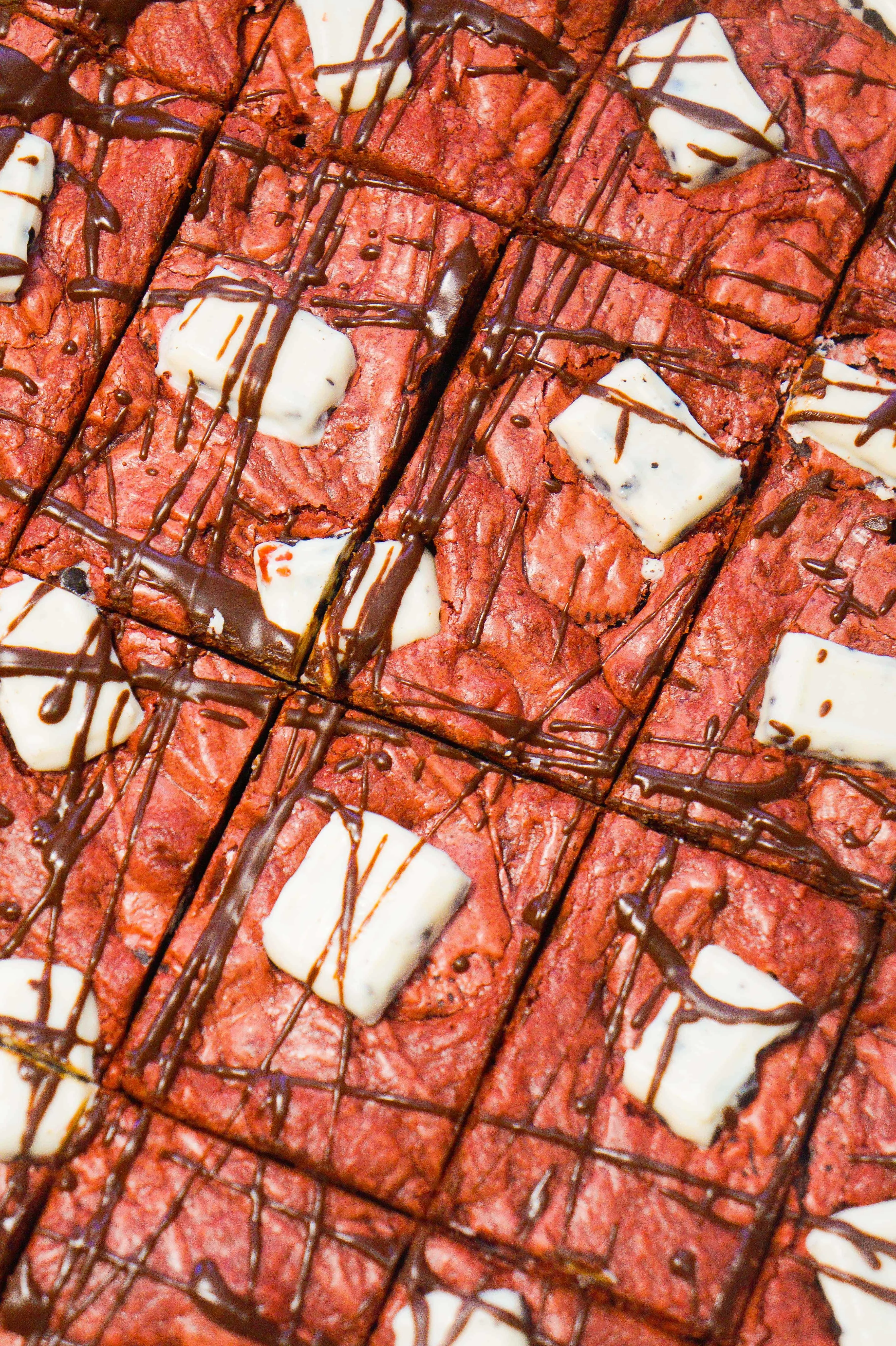 Easy red velvet cookie bars made with cake mix and loaded with mini Oreos.
