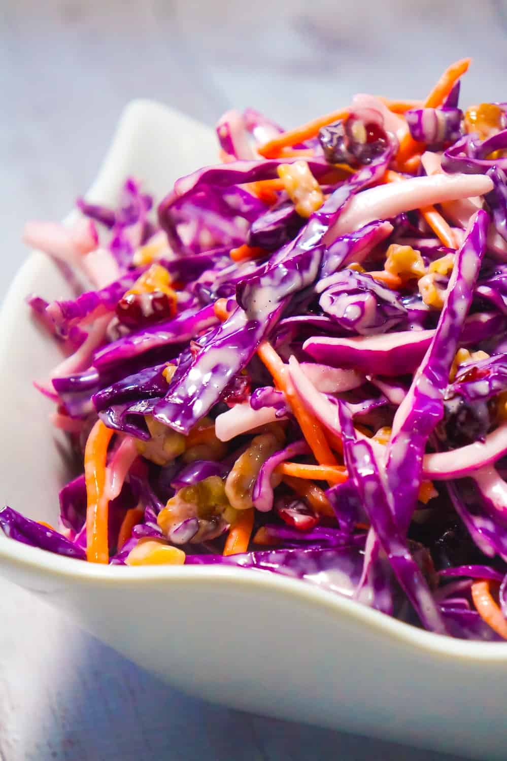 Cranberry Walnut Coleslaw is an easy side dish recipe perfect for summer. This colourful salad is made with red cabbage and loaded with carrots, red onion, dried cranberries and walnuts.