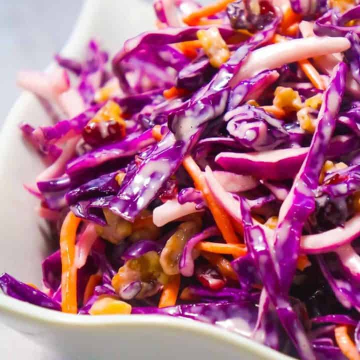 Cranberry Walnut Coleslaw is an easy side dish recipe perfect for summer. This colourful salad is made with red cabbage and loaded with carrots, red onion, dried cranberries and walnuts.