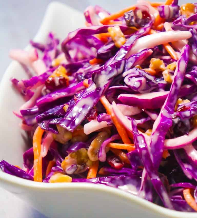 Cranberry Walnut Coleslaw is an easy side dish recipe perfect for summer. This colourful salad is made with red cabbage and loaded with carrots, red onion, dried cranberries and walnuts.