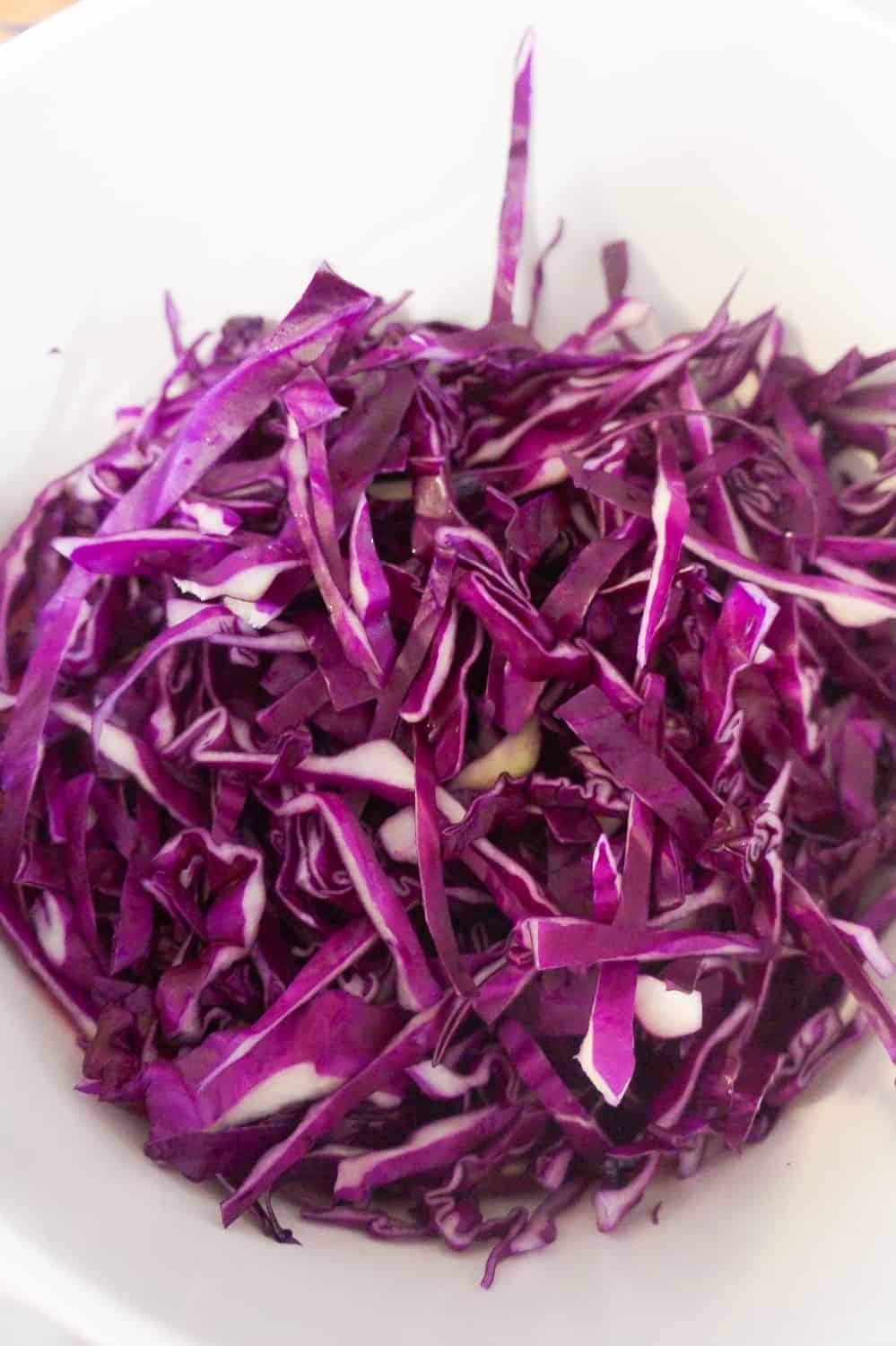 shredded red cabbage in mixing bowl