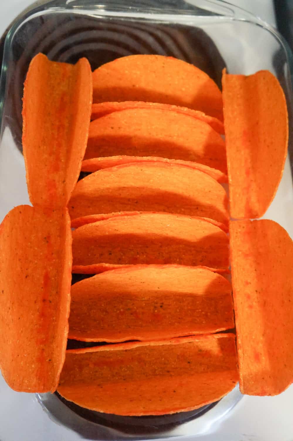 orange stand and stuff taco shells in a baking dish