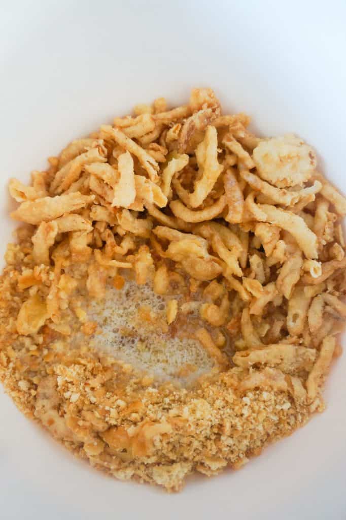 crushed Ritz crackers, fried onions and melted butter in a mixing bowl