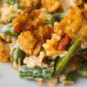Cream Cheese and Bacon Green Bean Casserole is an easy side dish recipe perfect for Thanksgiving or Christmas. This creamy green bean casserole is loaded with real bacon bits and topped with Ritz Crackers and French's Fried Onions.