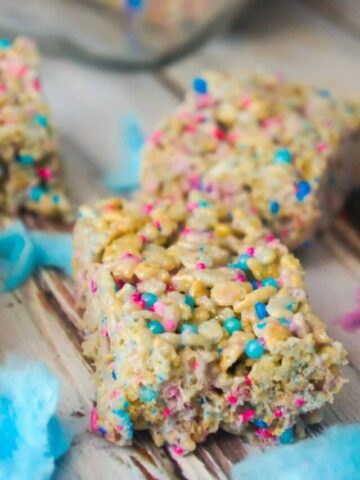 Cotton Candy Rice Krispie Treats are an easy dessert recipe your kids will love. These rice krispie squares are made with melted cotton candy and loaded with cotton candy coloured sprinkles.