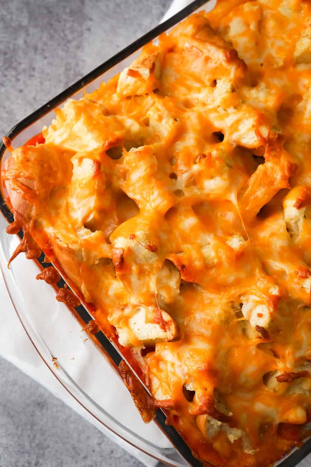 Easy Ground Chicken Casserole is a simple but delicious dinner recipe. The ground chicken base is topped with marinara sauce and cheesy garlic bread topping. This easy casserole is the best ground chicken recipe.