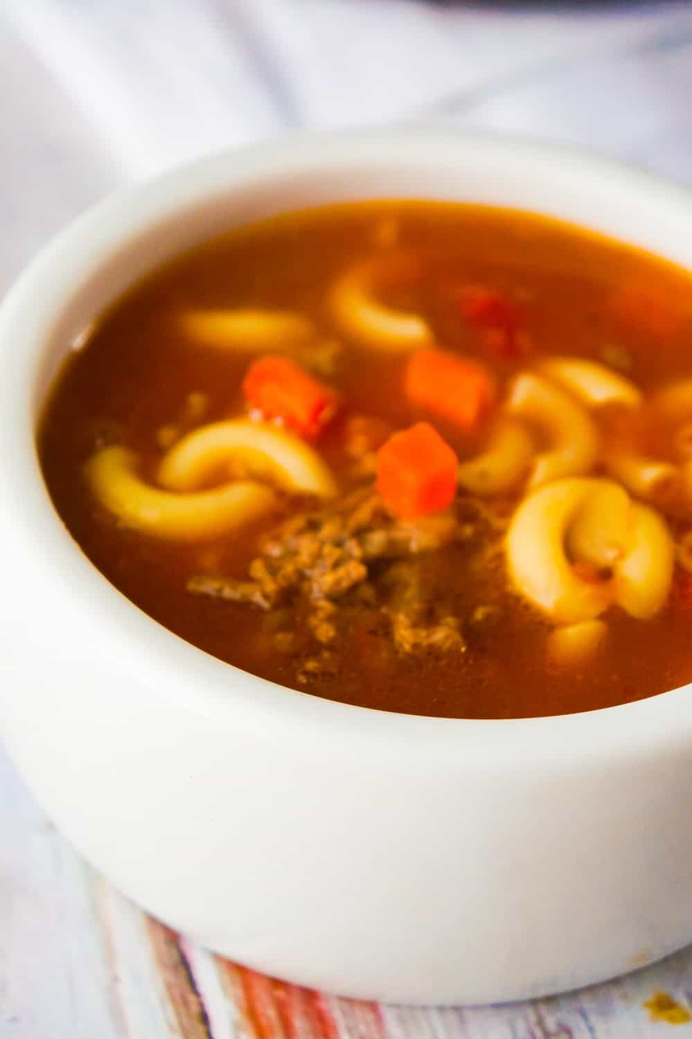 Easy Hamburger Soup with Macaroni is a hearty soup recipe that takes just fifteen minutes from start to finish.This delicious soup is loaded with ground beef, diced tomatoes, mixed vegetables and macaroni noodles.