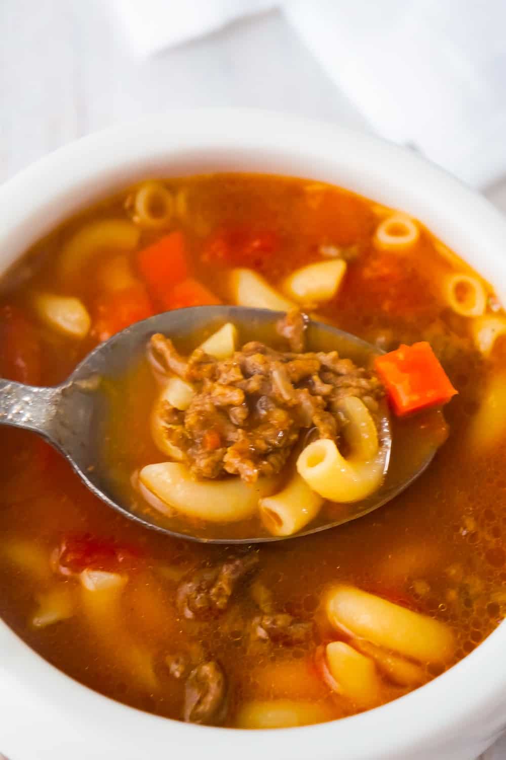 Easy Hamburger Soup with Macaroni is a hearty soup recipe that takes just fifteen minutes from start to finish.This delicious soup is loaded with ground beef, diced tomatoes, mixed vegetables and macaroni noodles.