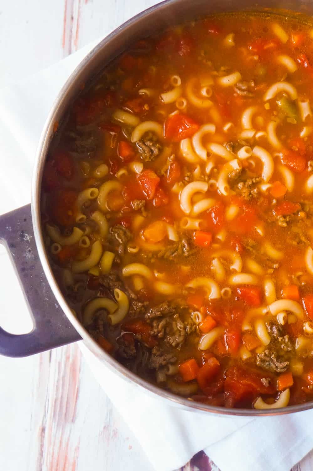 Easy Hamburger Soup with Macaroni is a hearty soup recipe that takes just fifteen minutes from start to finish.This delicious soup is loaded with ground beef, diced tomatoes, mixed vegetables and macaroni noodles.